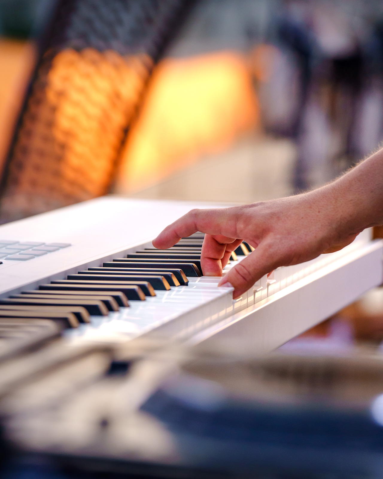 Musician performing on piano at a live event